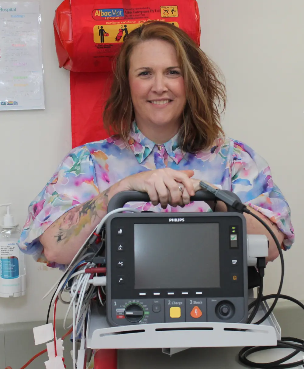 Kelly Amber of Ambling Along Tours and Transfers with the defibrillator at Wonthaggi Hospital’s maternity unit bought with the proceeds of a golf day at Phillip Island Golf Club.