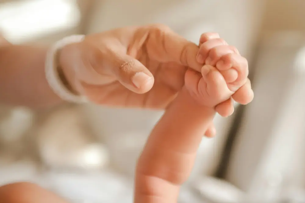 Maternity_mum_and_baby_holding_hands.jpg